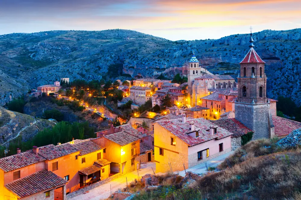 Albarracin, Spain in the evening with historic buildings illuminated at sunset