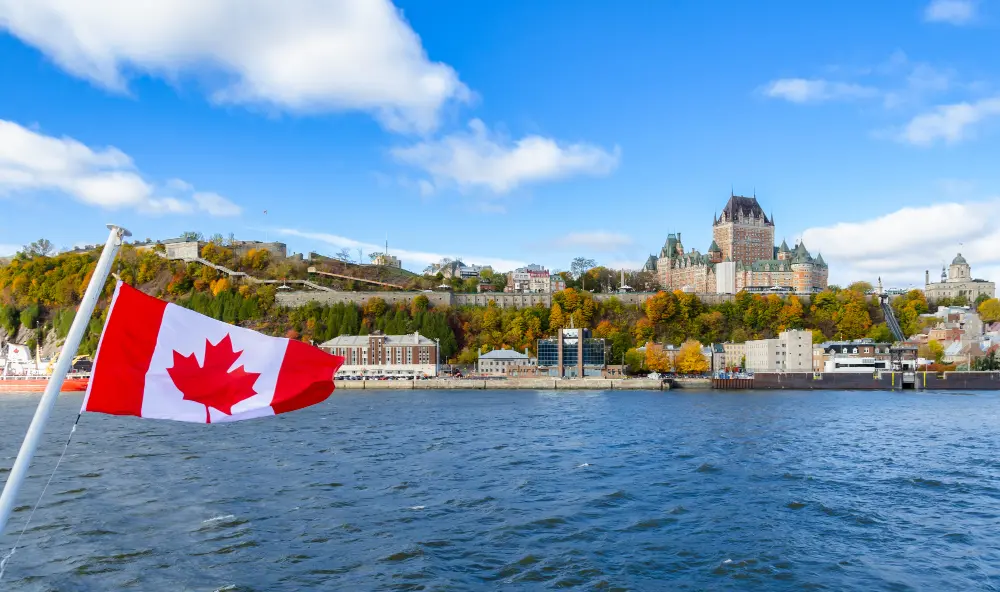 Scenic Canadian landscape with mountains, lake, and evergreen trees under a clear sky