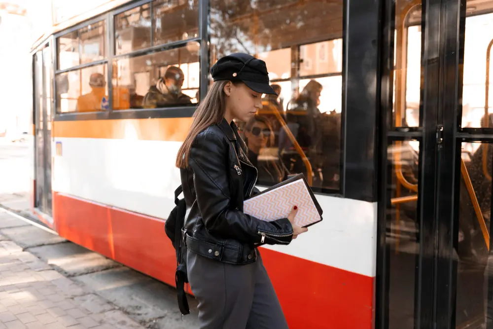 Traveler using a metro map and smartphone to plan local transportation in a city