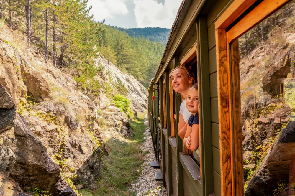 mother daughter trips on a budget enjoying a scenic train journey through mountains