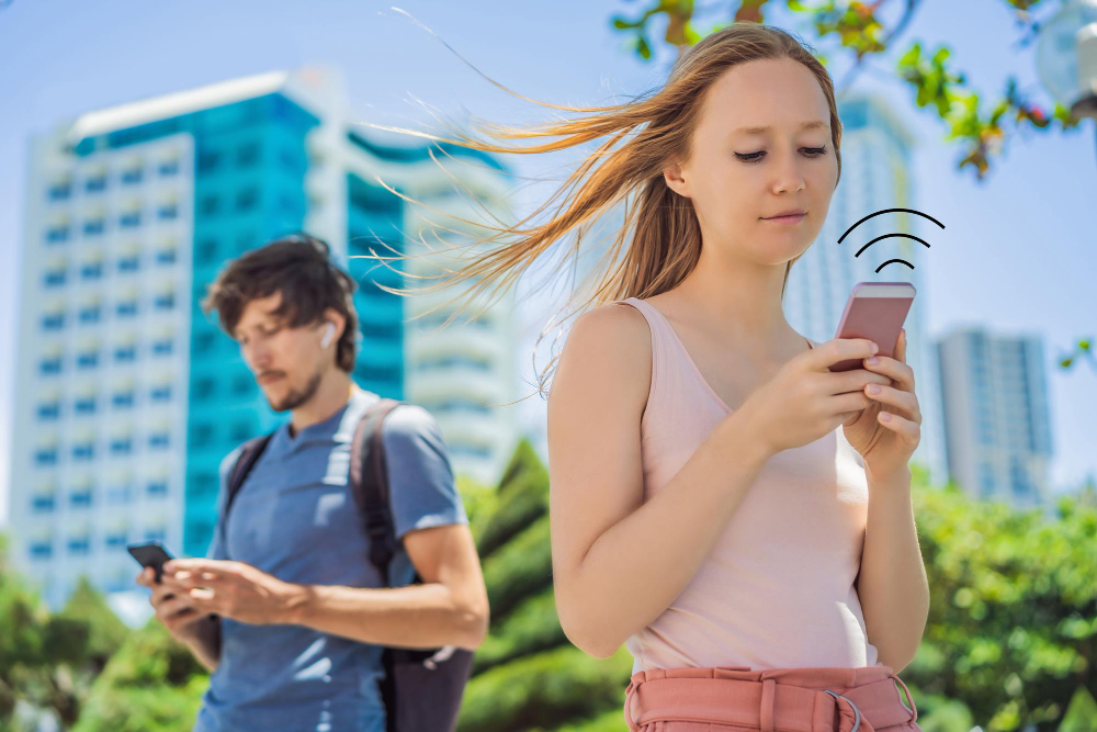 Traveler using public WiFi at a cafe while being cautious about online security on a laptop
