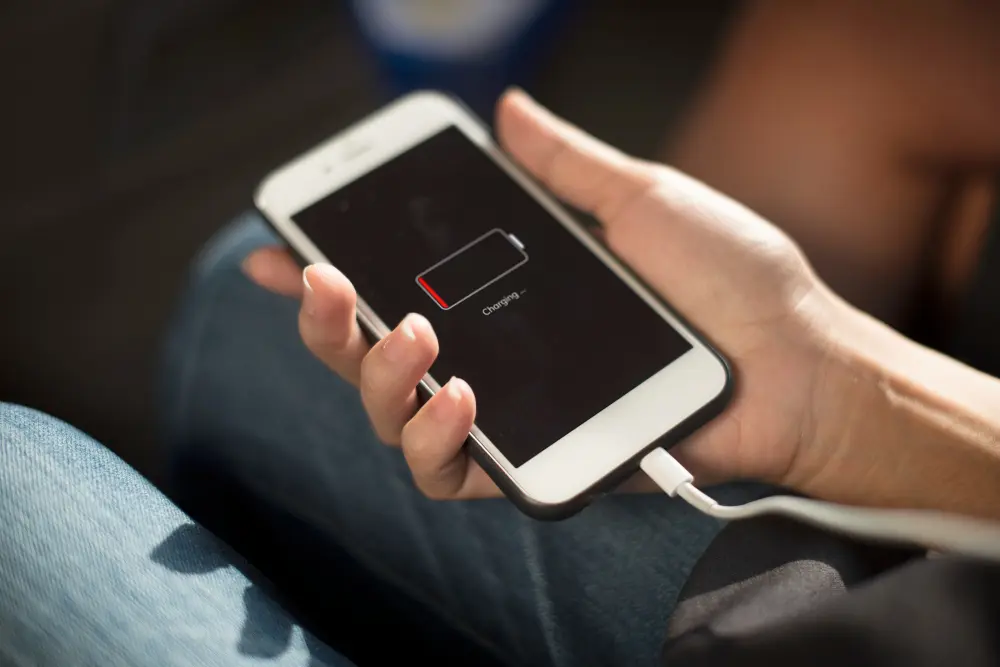 Traveler adjusting smartphone settings to save battery life and mobile data while traveling