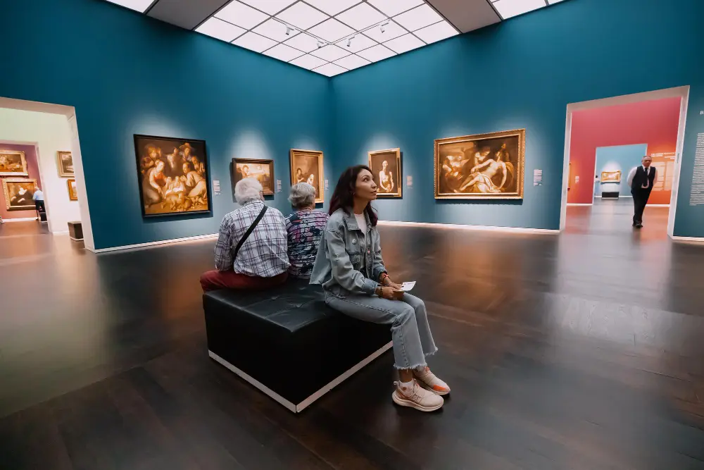 Traveler reviewing tour tickets and attraction prices while updating a travel budget planner for activities and experiences