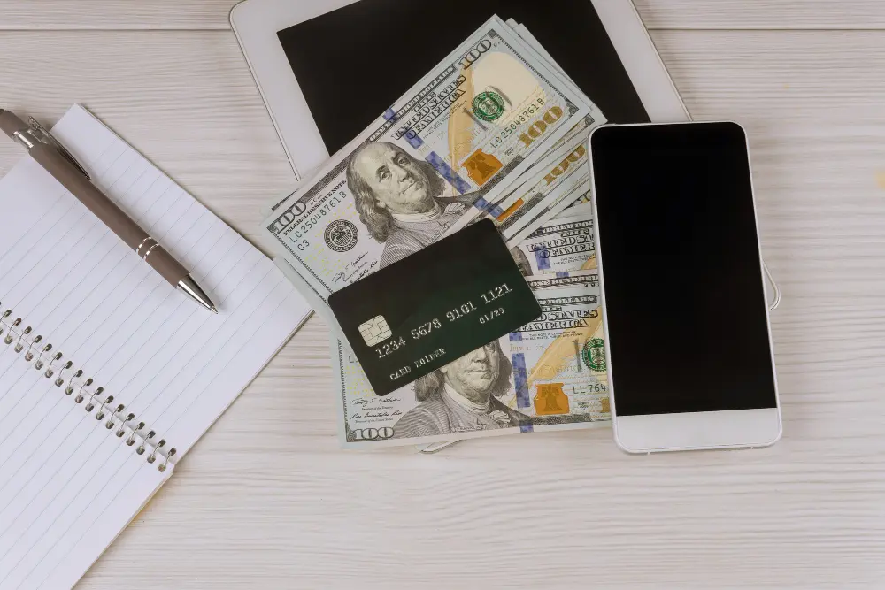 Traveler blocking a lost credit card on a phone call while holding cash abroad