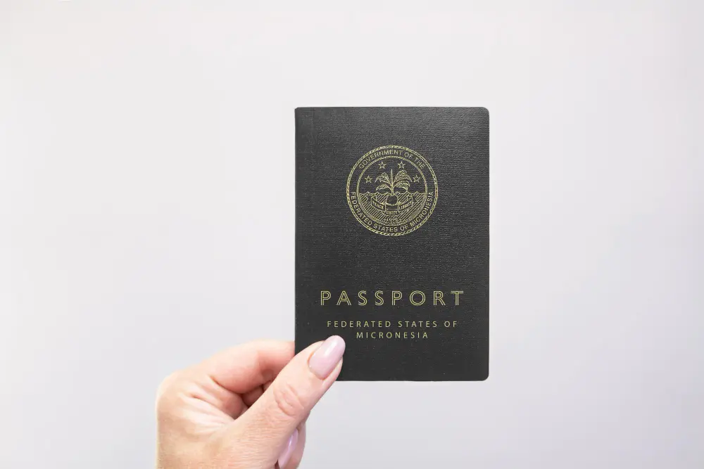 Traveler holding an open passport at an international airport departure gate