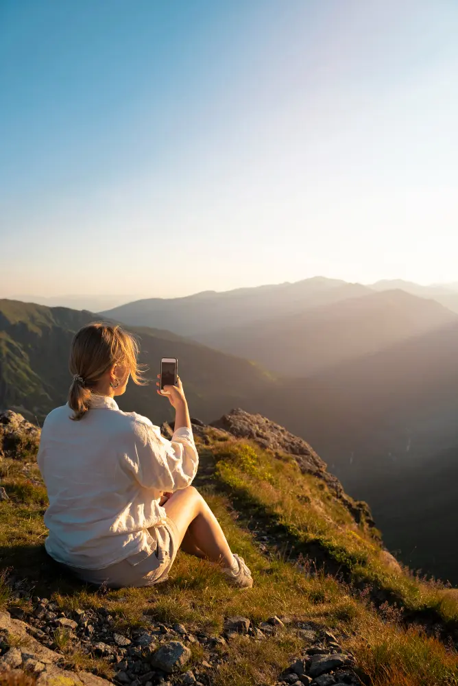 Travelers watching a colorful sunset at a scenic overlook, turning ordinary road stops into unforgettable travel moments