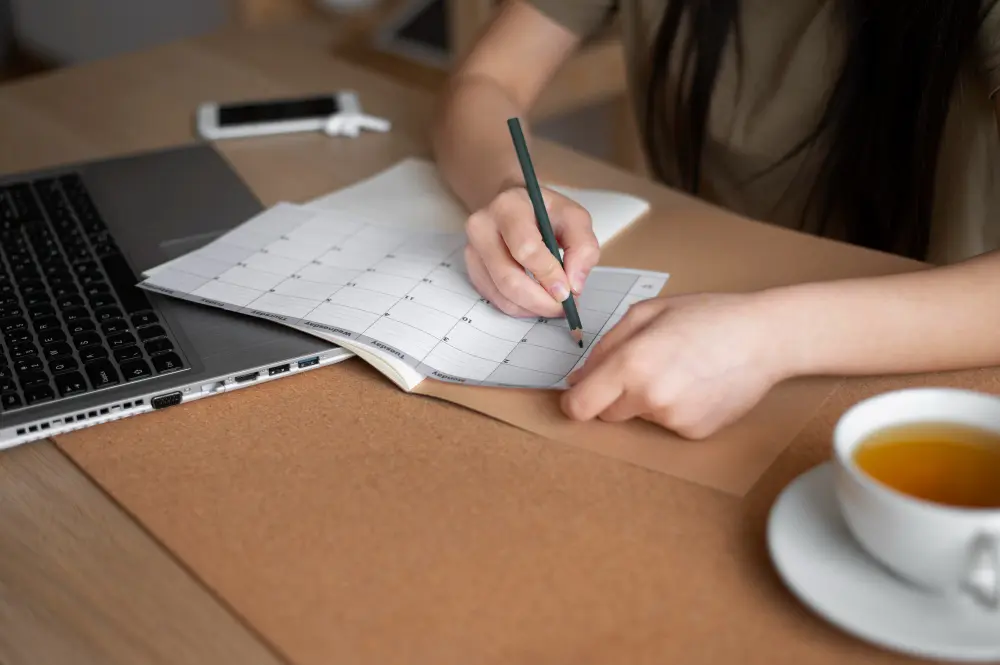 how to plan a budget trip with laptop, travel notes, and budget planning list