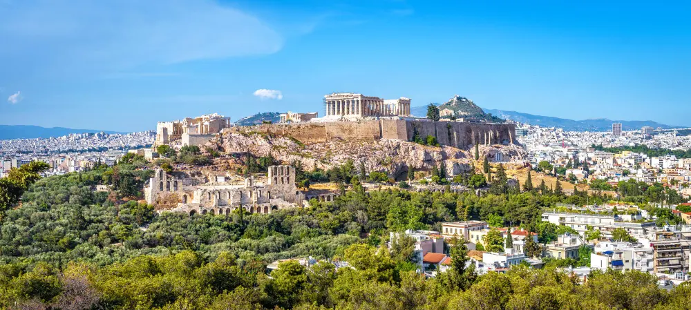 Aerial view of the Acropolis and Parthenon overlooking Athens, Greece, a must-visit stop when planning a trip to Greece