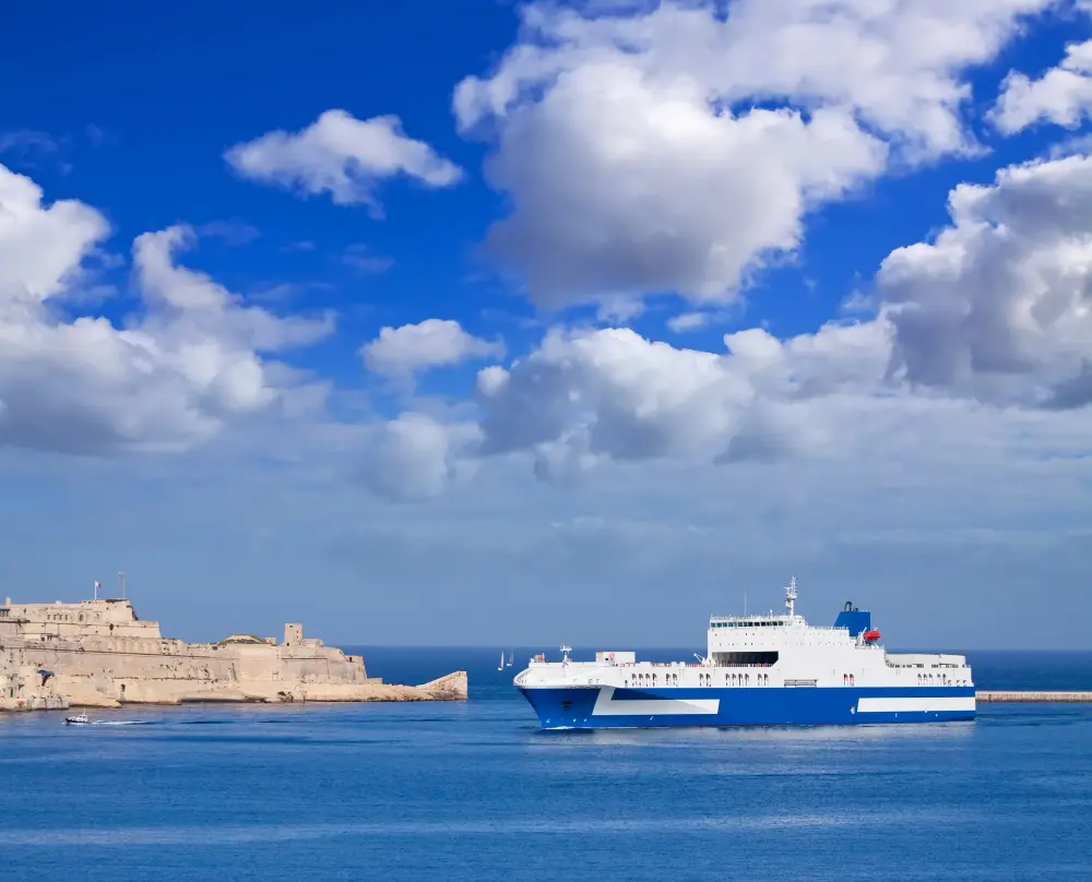 A white ferry boat sailing through the blue Aegean Sea between Greek islands, the main way to travel between islands in Greece