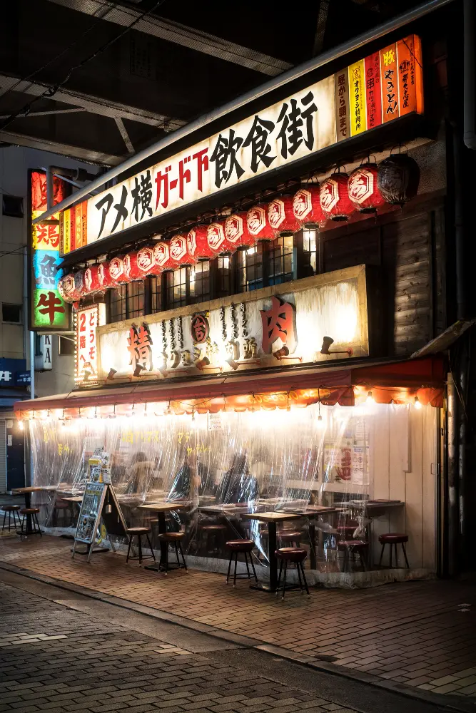 A steaming bowl of traditional ramen on a wooden counter at a local izakaya, showing how to travel in Japan and eat like a local expert.