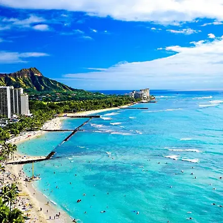 Small inter-island airplane flying over turquoise Hawaiian waters connecting Oahu, Maui, Kauai, and the Big Island for travelers planning round trip tickets to Hawaii
