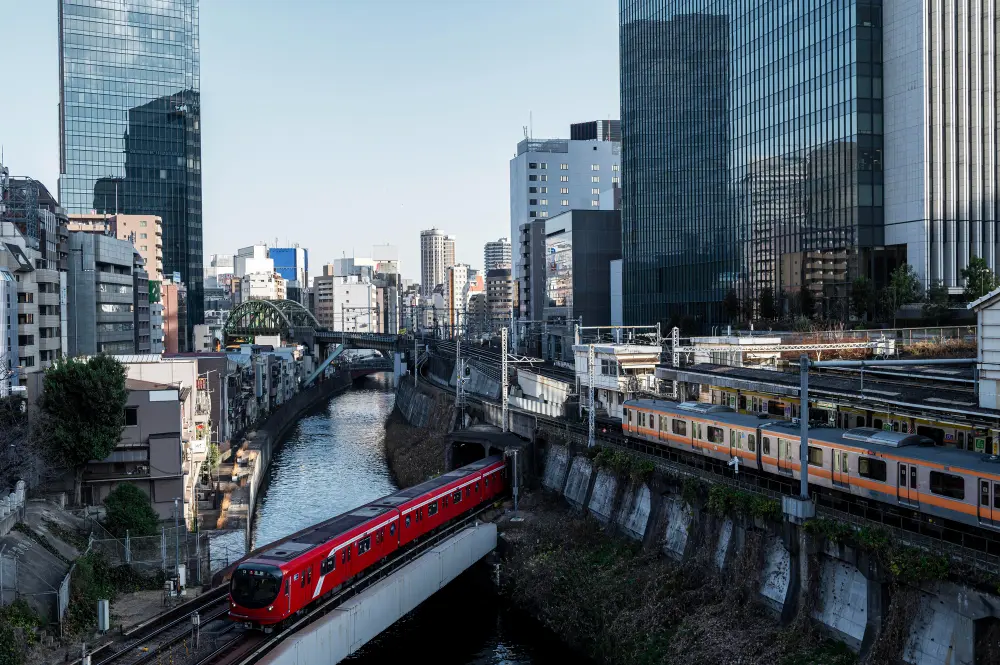 A sleek Shinkansen bullet train at a station platform, representing one of the main transport expenses when figuring out how much is it to travel to japan.