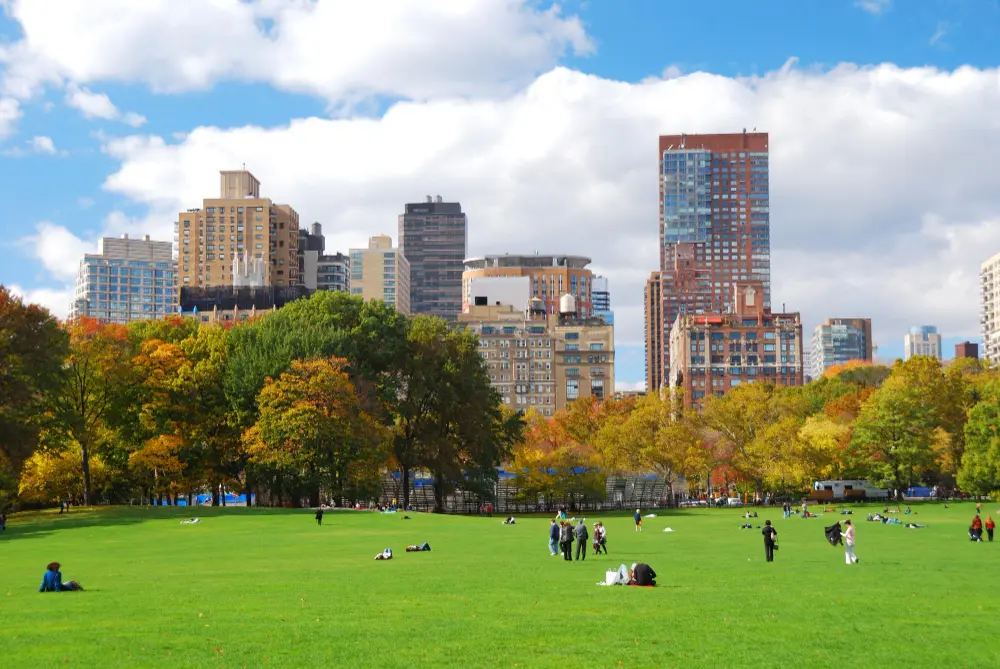Traveler planning a New York City itinerary with a map, notebook, and coffee on a table