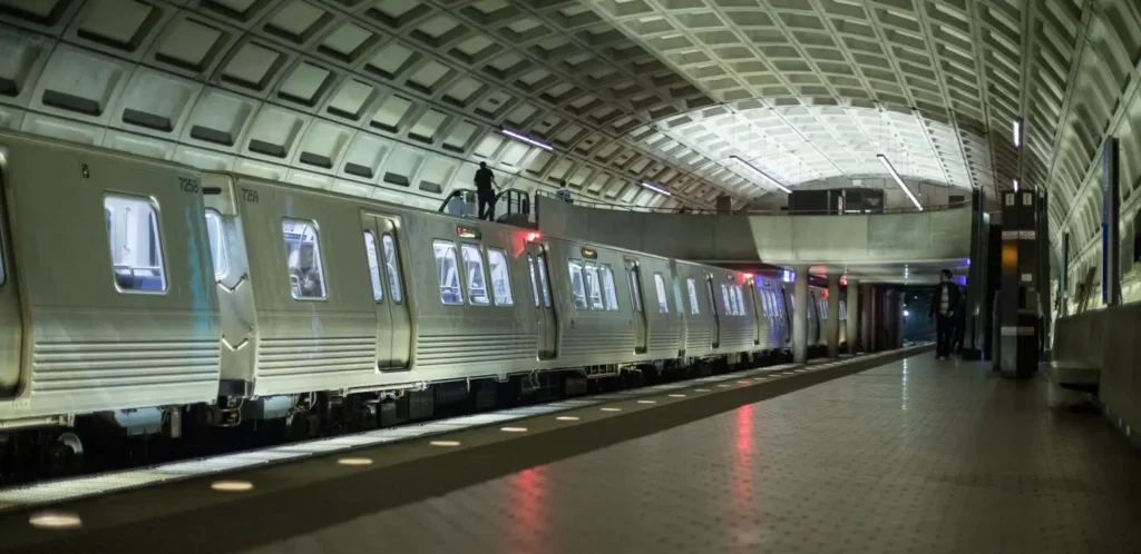A Washington DC Metro train arriving at a station, an essential part of learning how to plan a trip to washington dc.