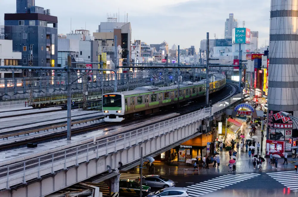A sleek Japanese bullet train arriving at a station, representing the primary transportation method to consider when planning how much does it cost to travel japan.